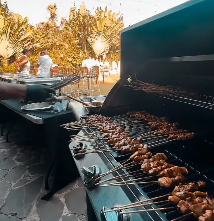 Private chef grilling satay skewers and steak at a Bali villa BBQ
